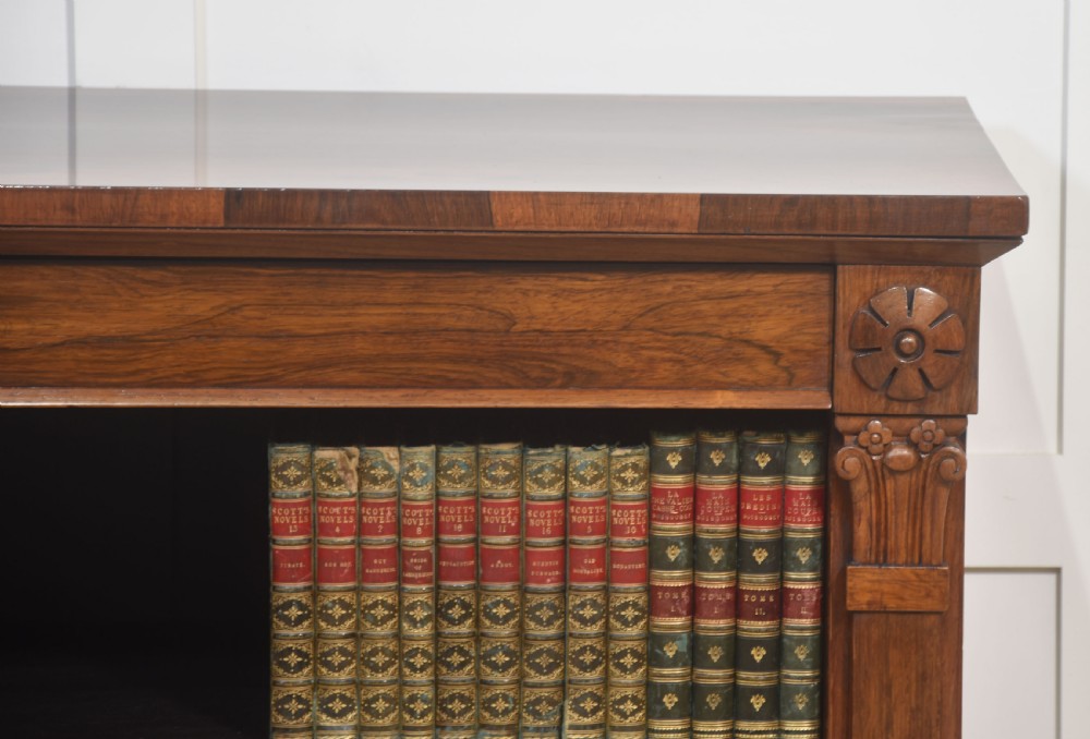 A 19th-century rosewood open bookcase featuring three open shelves, carved corner rosettes, pilasters, and a solid plinth base. View II
