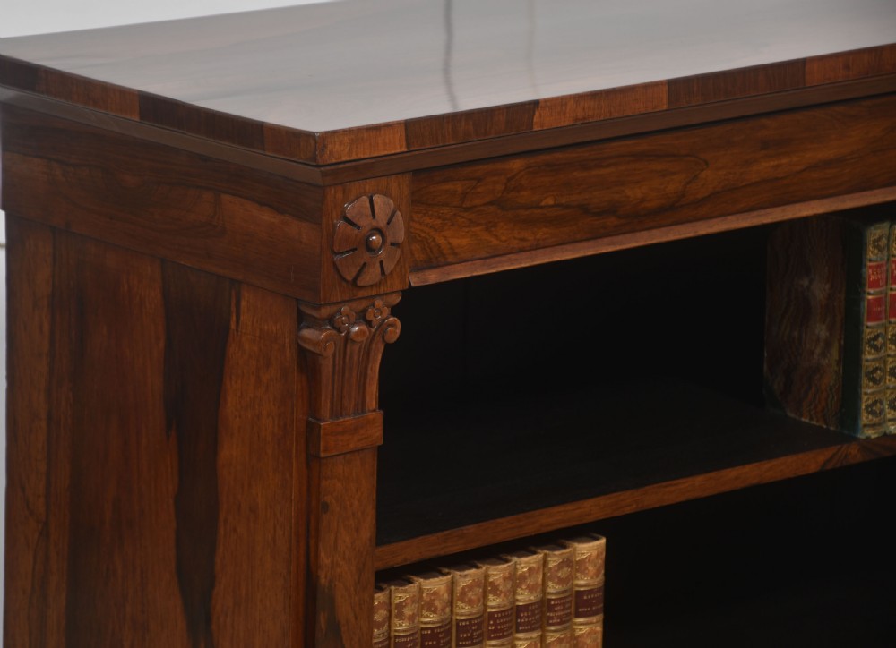 A 19th-century rosewood open bookcase featuring three open shelves, carved corner rosettes, pilasters, and a solid plinth base. View III