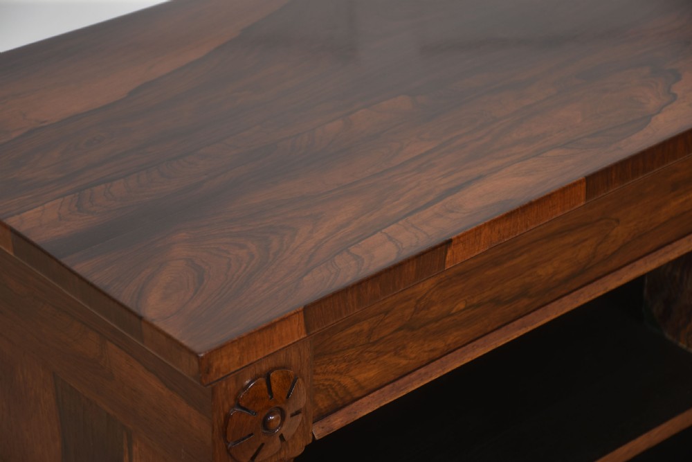 A 19th-century rosewood open bookcase featuring three open shelves, carved corner rosettes, pilasters, and a solid plinth base. View VIII