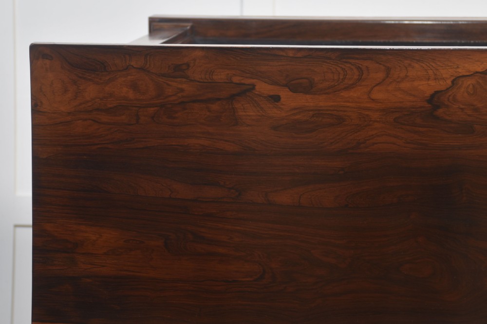 A 19th-century rosewood open bookcase featuring three open shelves, carved corner rosettes, pilasters, and a solid plinth base. View XV