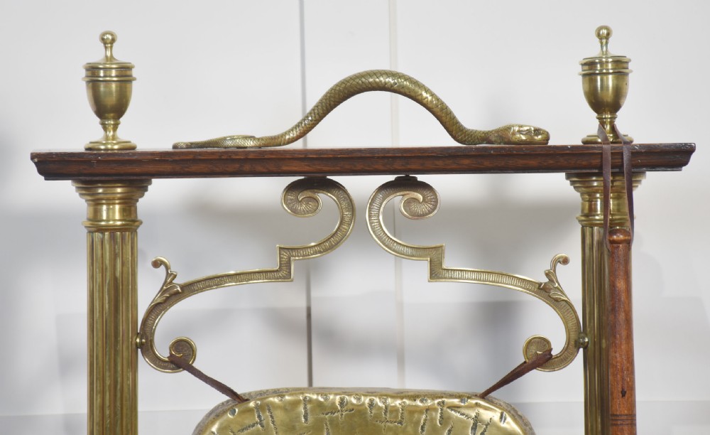 An antique brass table gong suspended within an oak frame with fluted brass columns, a serpent motif top handle, and a suspended mallet. View VII