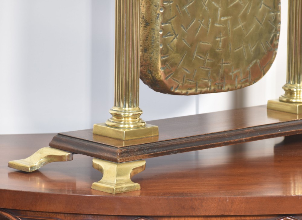 An antique brass table gong suspended within an oak frame with fluted brass columns, a serpent motif top handle, and a suspended mallet. View VIII