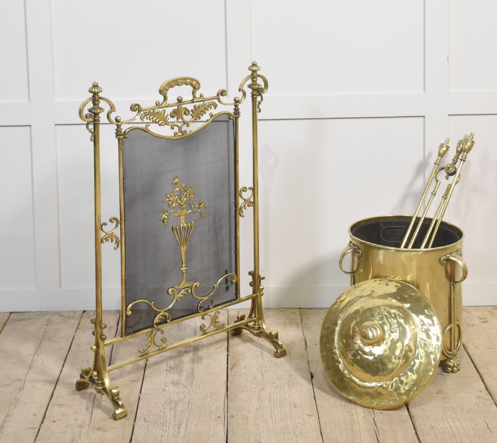 A cylindrical polished brass Art Nouveau coal bin featuring stylised cast feet, side handles, and a domed lid with a finial handle. View VIII
