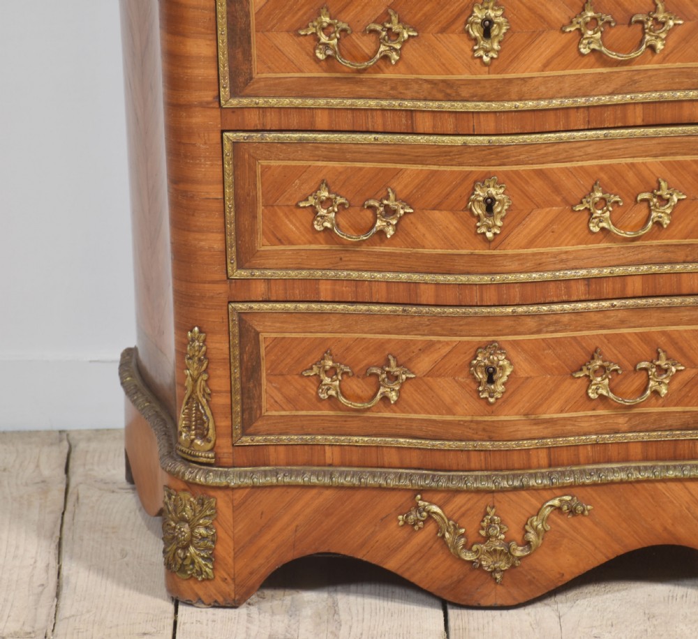A tall, narrow French kingwood secretaire abattant featuring herringbone parquetry inlay, brass ormolu mounts, and seven drawer fronts with decorative handles. View III