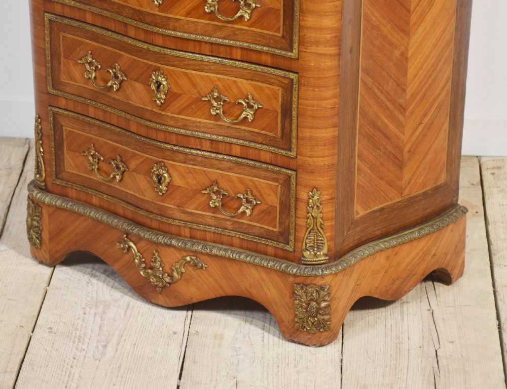 A tall, narrow French kingwood secretaire abattant featuring herringbone parquetry inlay, brass ormolu mounts, and seven drawer fronts with decorative handles. View VIII