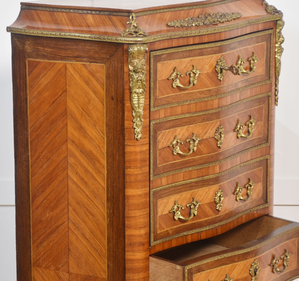 A tall, narrow French kingwood secretaire abattant featuring herringbone parquetry inlay, brass ormolu mounts, and seven drawer fronts with decorative handles. View XI