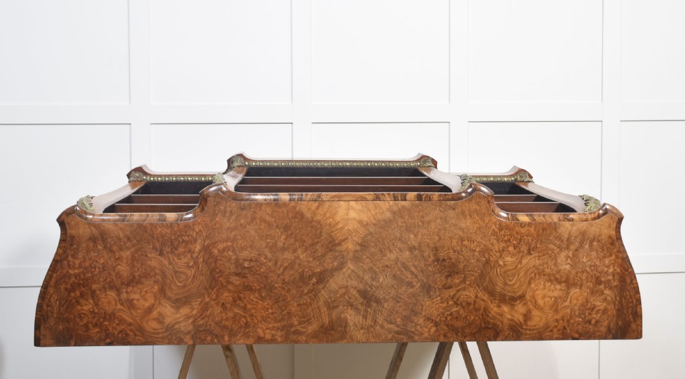 An antique figured walnut breakfront open bookcase featuring three shelf compartments and ornamental gilt metal mounts along the frieze and pilasters. View XIX