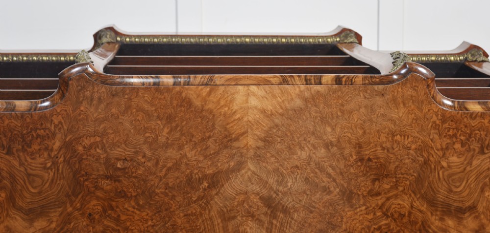 An antique figured walnut breakfront open bookcase featuring three shelf compartments and ornamental gilt metal mounts along the frieze and pilasters. View XX