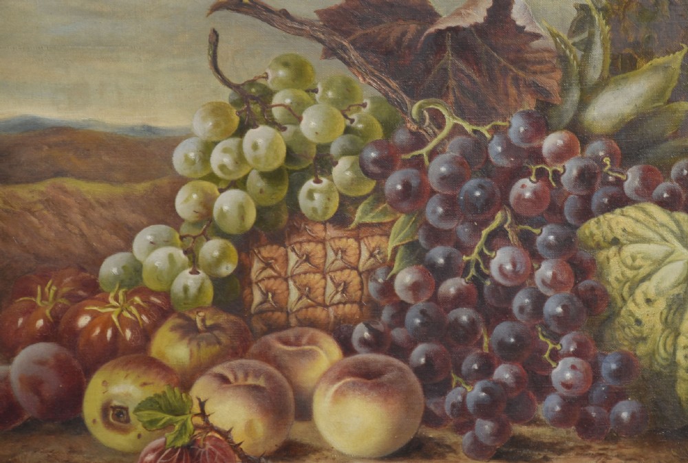 An antique oil on canvas still life painting depicting an arrangement of grapes, peaches, and melons within an ornate gilded frame. View II