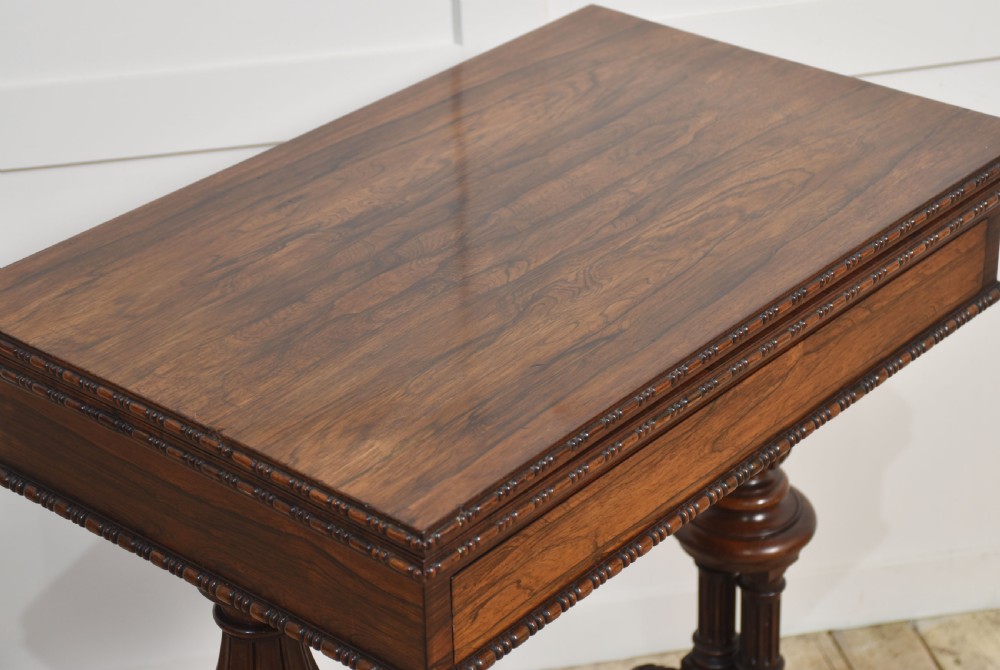 A 19th-century rosewood fold-over card table featuring turned legs, carved pedestals, and a stretcher base. View IX