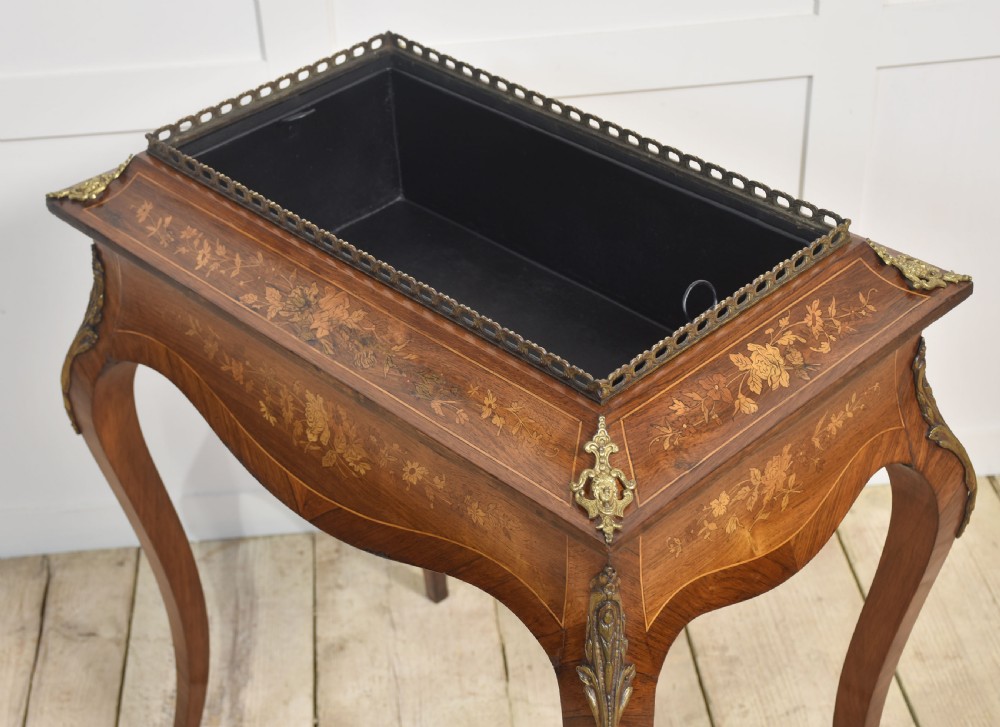 A 19th-century French style mahogany jardiniere table with floral marquetry inlay, cabriole legs, cast brass mounts, a pierced gallery rail, and a removable top panel. View VIII