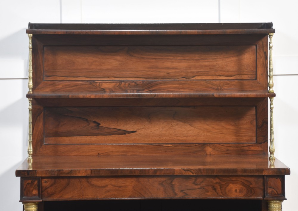 A 19th-century rosewood open bookcase featuring brass pillar supports, a tiered upper shelf gallery, open lower shelves, and turned feet. View III
