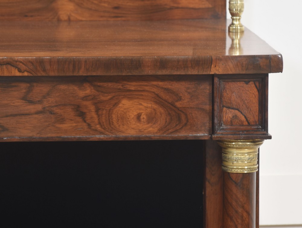 A 19th-century rosewood open bookcase featuring brass pillar supports, a tiered upper shelf gallery, open lower shelves, and turned feet. View V
