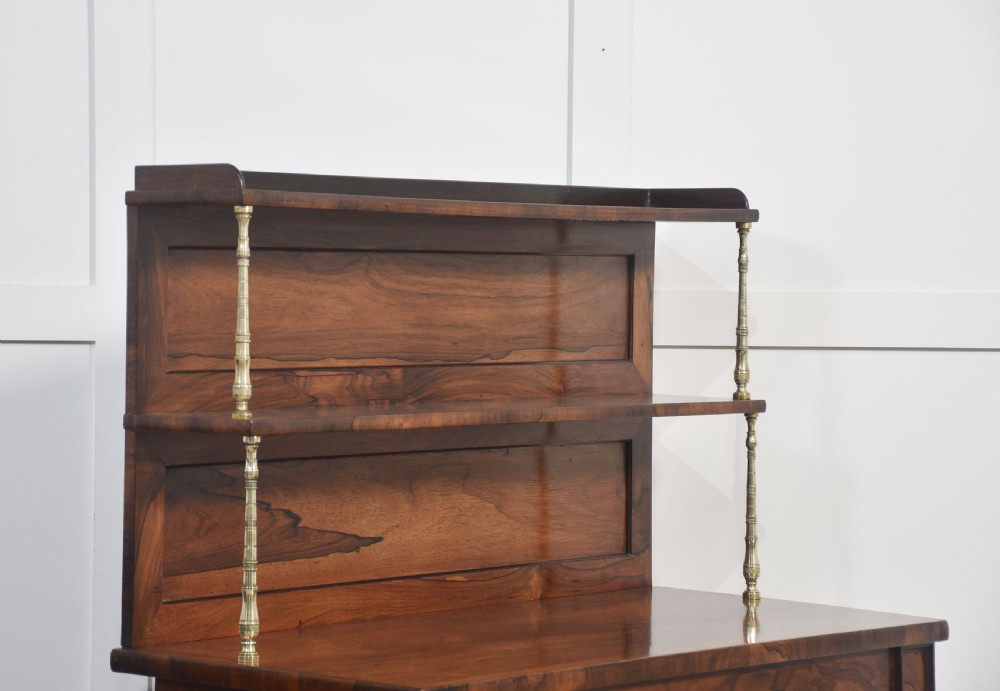 A 19th-century rosewood open bookcase featuring brass pillar supports, a tiered upper shelf gallery, open lower shelves, and turned feet. View XI