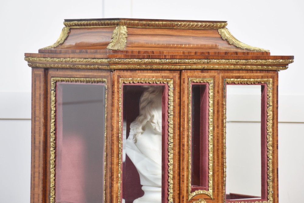 An antique kingwood glazed display cabinet elevated on cabriole legs with decorative gilt bronze mounts and a burgundy fabric interior. View III