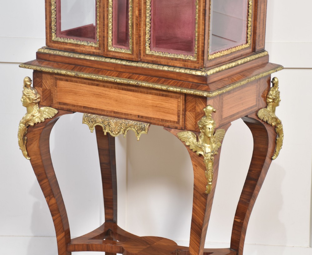 An antique kingwood glazed display cabinet elevated on cabriole legs with decorative gilt bronze mounts and a burgundy fabric interior. View XIV