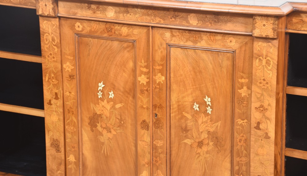 A low antique walnut breakfront bookcase featuring floral marquetry inlay across the central cupboard doors and top frieze, flanked by open adjustable shelves. View XIV