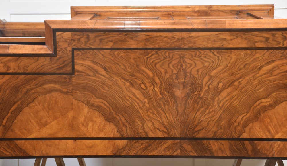A low antique walnut breakfront bookcase featuring floral marquetry inlay across the central cupboard doors and top frieze, flanked by open adjustable shelves. View XVIII