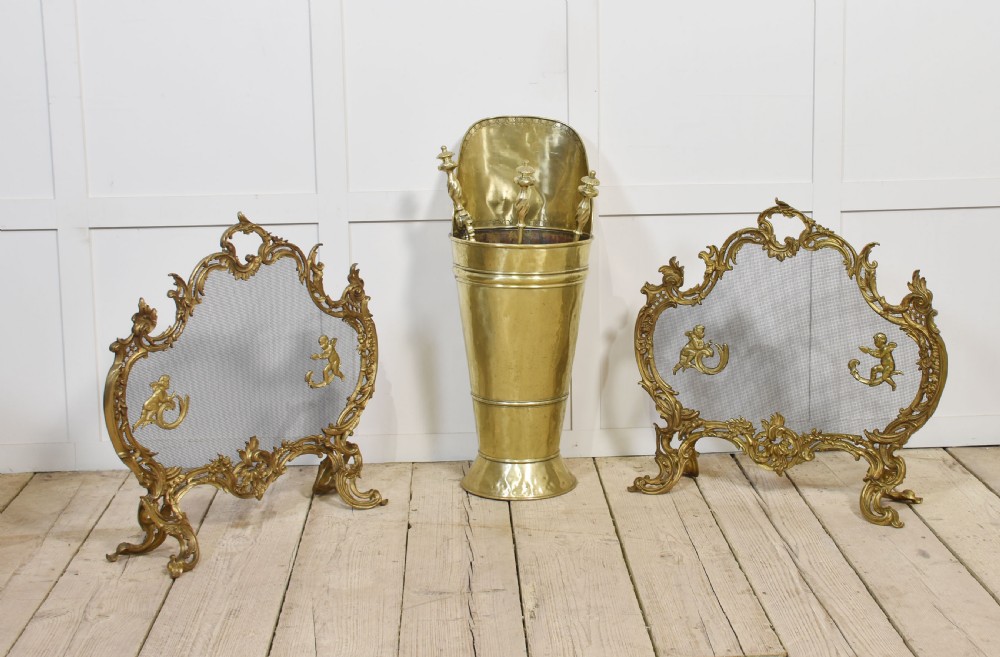 A pair of ornate Louis XV style gilt bronze fire screens featuring Rococo scrollwork, cherub mounts, and wire mesh panels on cabriole feet. View VIII