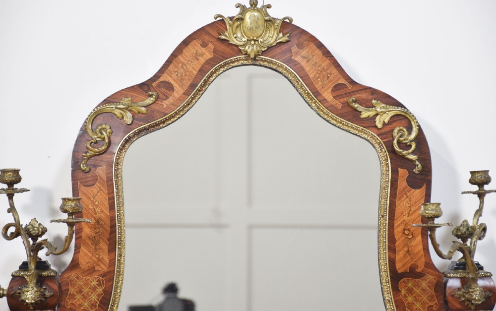A Louis Philippe tulipwood dressing table featuring floral marquetry inlay, gilt bronze ormolu mounts, a shaped mirror with attached sconces, and cabriole legs. View VII
