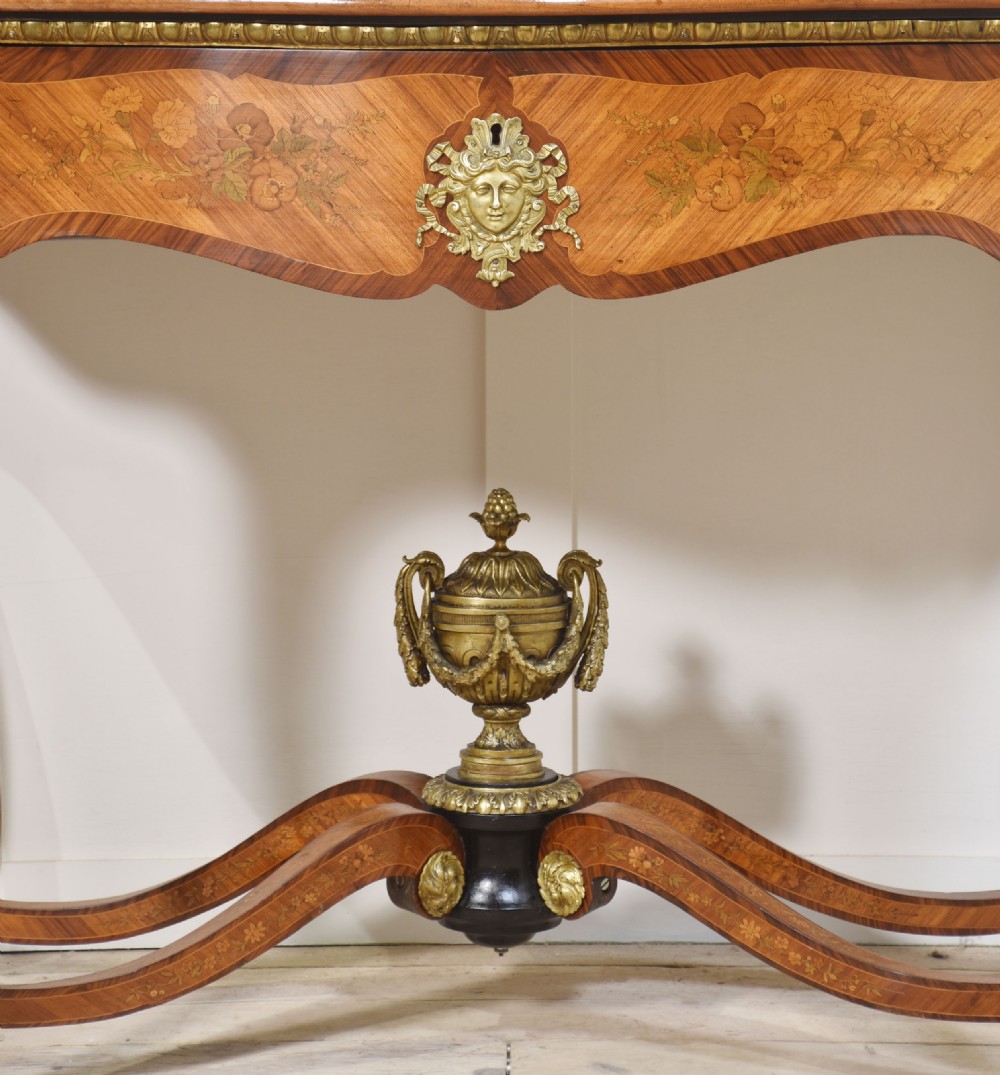 A Louis Philippe tulipwood dressing table featuring floral marquetry inlay, gilt bronze ormolu mounts, a shaped mirror with attached sconces, and cabriole legs. View IX