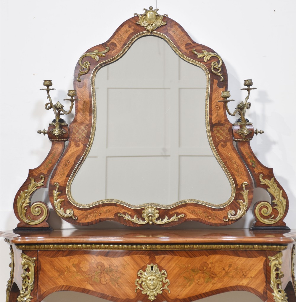 A Louis Philippe tulipwood dressing table featuring floral marquetry inlay, gilt bronze ormolu mounts, a shaped mirror with attached sconces, and cabriole legs. View XI