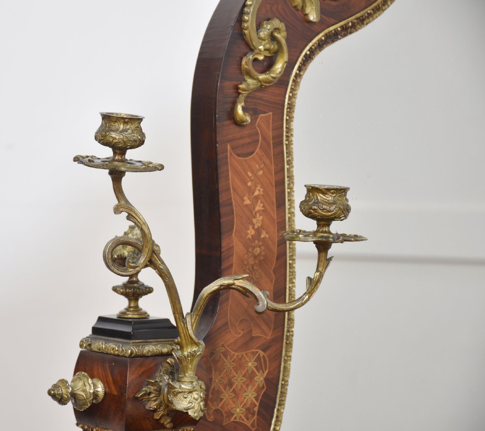 A Louis Philippe tulipwood dressing table featuring floral marquetry inlay, gilt bronze ormolu mounts, a shaped mirror with attached sconces, and cabriole legs. View XVIII