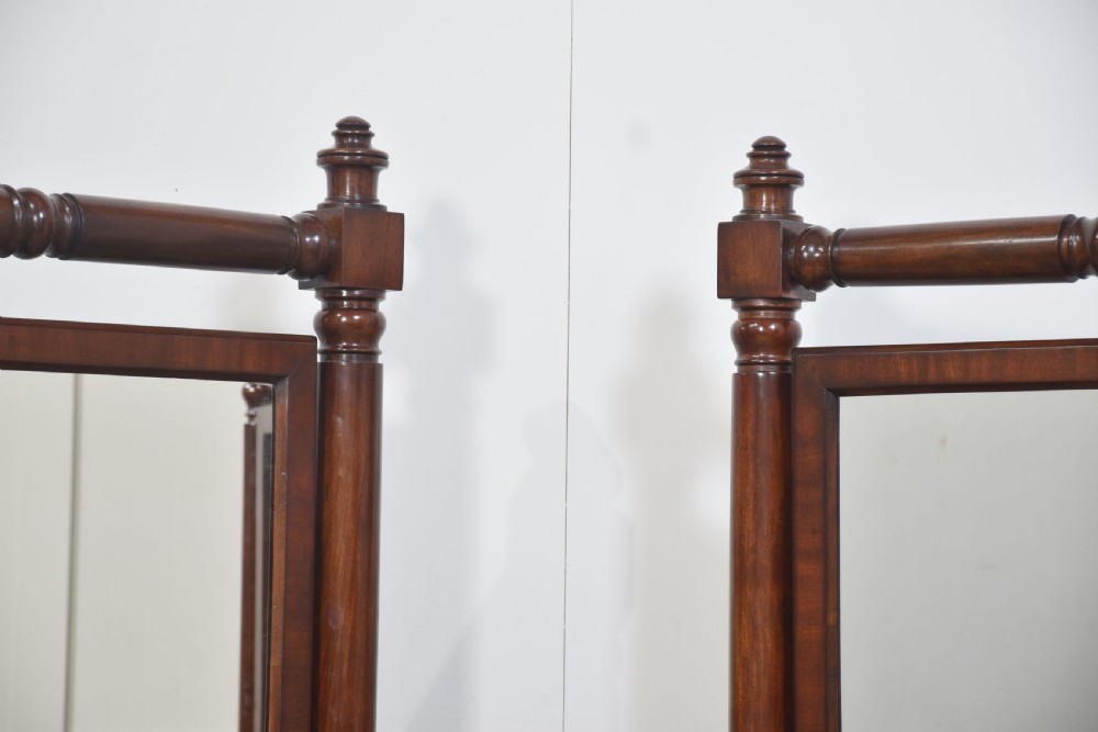 A pair of antique mahogany cheval mirrors featuring rectangular tilting glass plates, turned vertical supports, horizontal stretchers, and brass hardware. View III