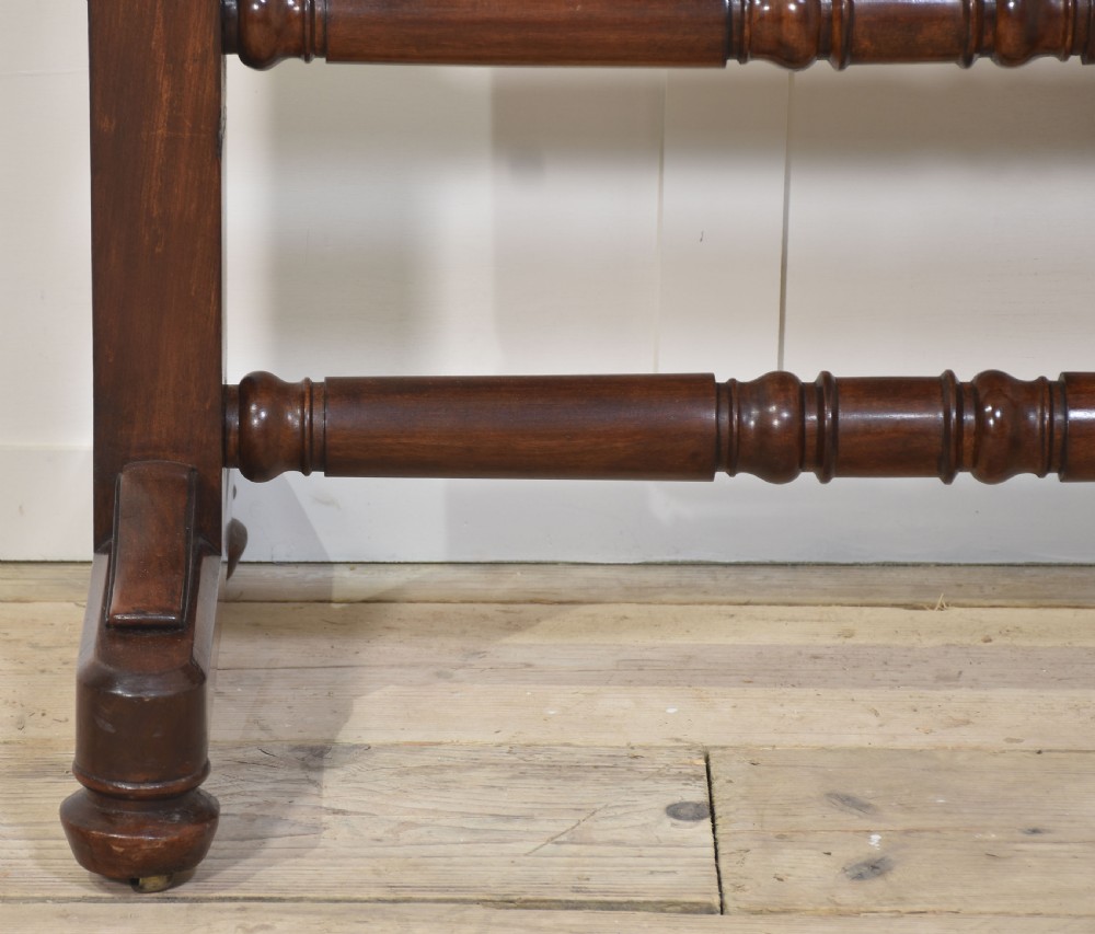 A pair of antique mahogany cheval mirrors featuring rectangular tilting glass plates, turned vertical supports, horizontal stretchers, and brass hardware. View IX