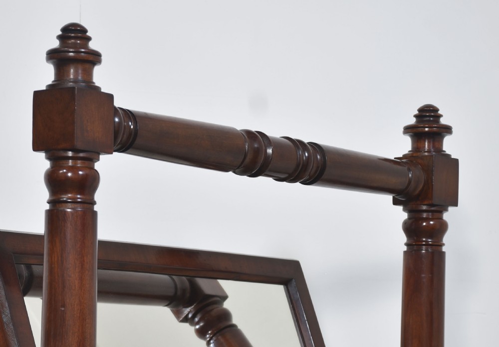 A pair of antique mahogany cheval mirrors featuring rectangular tilting glass plates, turned vertical supports, horizontal stretchers, and brass hardware. View XIV