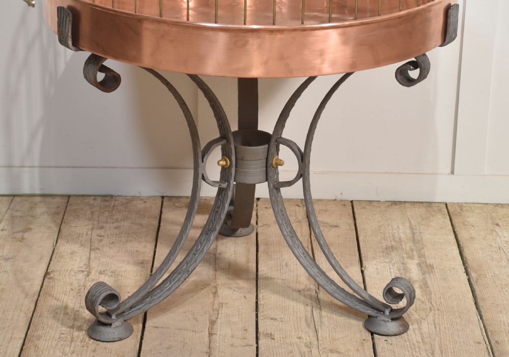 A large brass domed bird cage with a polished copper basin resting upon a grey wrought iron scrollwork stand. View IV