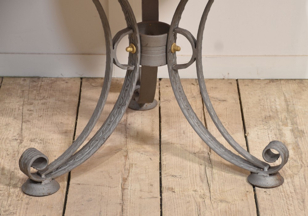 A large brass domed bird cage with a polished copper basin resting upon a grey wrought iron scrollwork stand. View IX