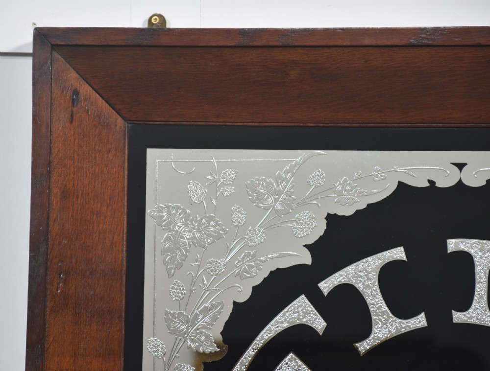 A square Victorian advertising mirror framed in dark wood, featuring silvered arched lettering reading FINE TEAS on a black painted glass ground. View III