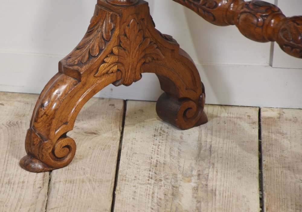 A freestanding carved oak frame featuring turned posts, scroll feet, and a central suspended round brass gong with an attached striker. View VIII