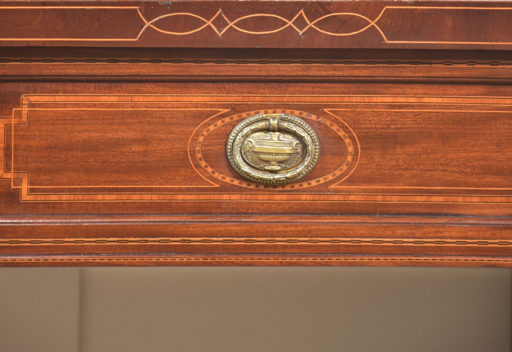 A 19th-century mahogany pedestal sideboard with satinwood oval panel inlays, reeded columns, five upper drawers, and a top brass gallery rail. View XVIII