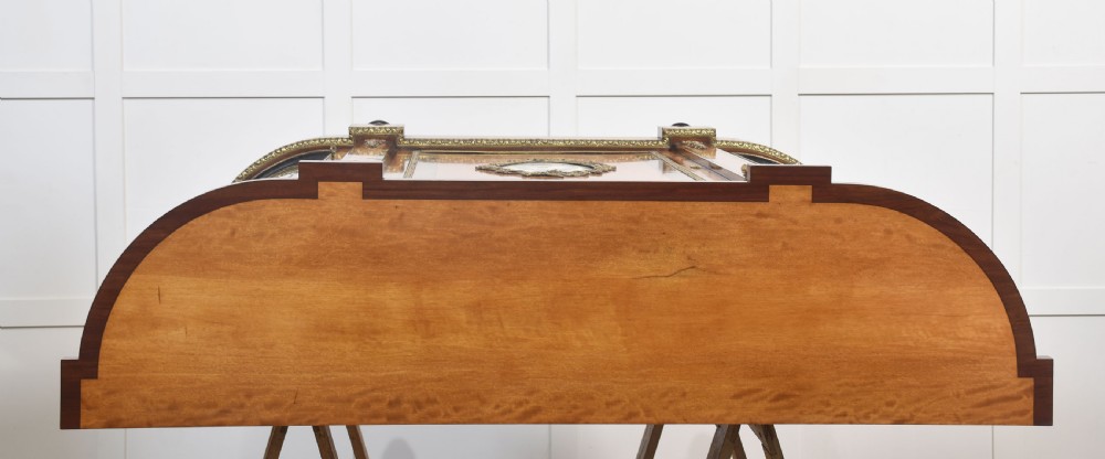 A 19th-century satinwood credenza featuring curved glass side display doors, a central solid panel door set with a porcelain plaque, and gilded ormolu mounts throughout. View XV