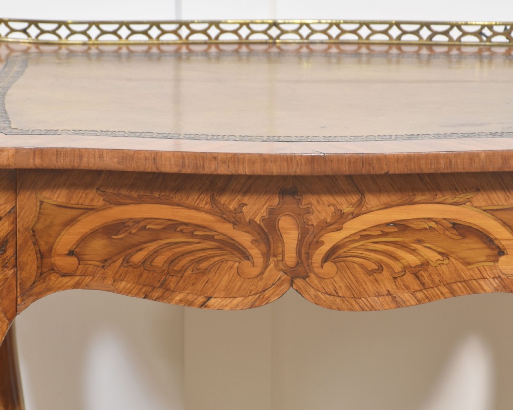 A French Louis XV style kingwood side table featuring a leather inset top with a pierced brass gallery, marquetry inlaid frieze, cabriole legs, and ornate gilt-metal mounts. View VIII
