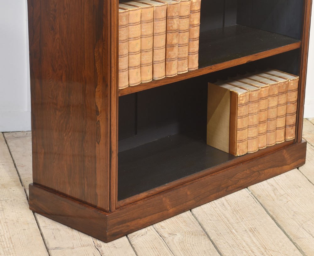 A 19th-century dark rosewood open bookcase featuring three tiers of shelving, a gallery top, corner roundels, and a solid plinth base. View III