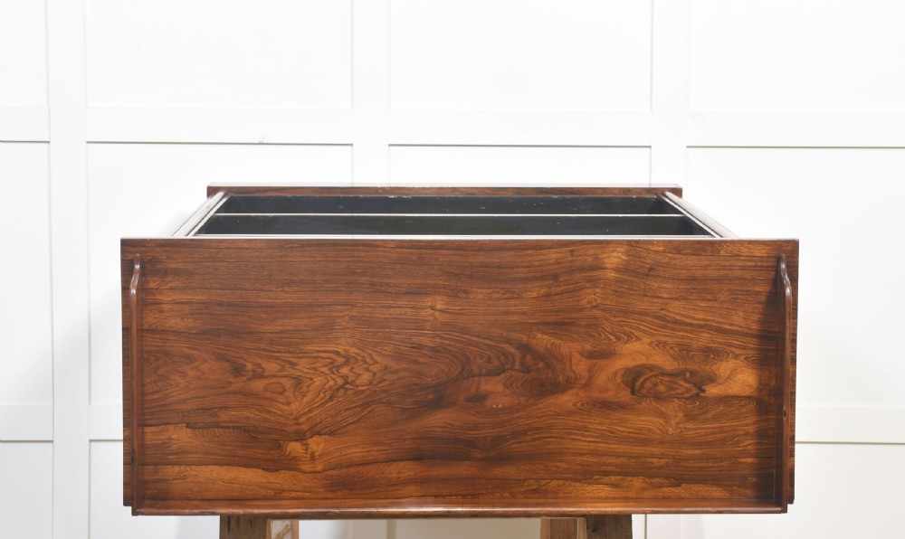 A 19th-century dark rosewood open bookcase featuring three tiers of shelving, a gallery top, corner roundels, and a solid plinth base. View XIII