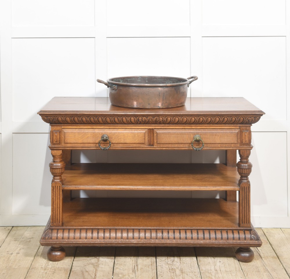 A large, wide, round 19th-century copper preserve pan featuring a rolled rim and two riveted loop handles. View II