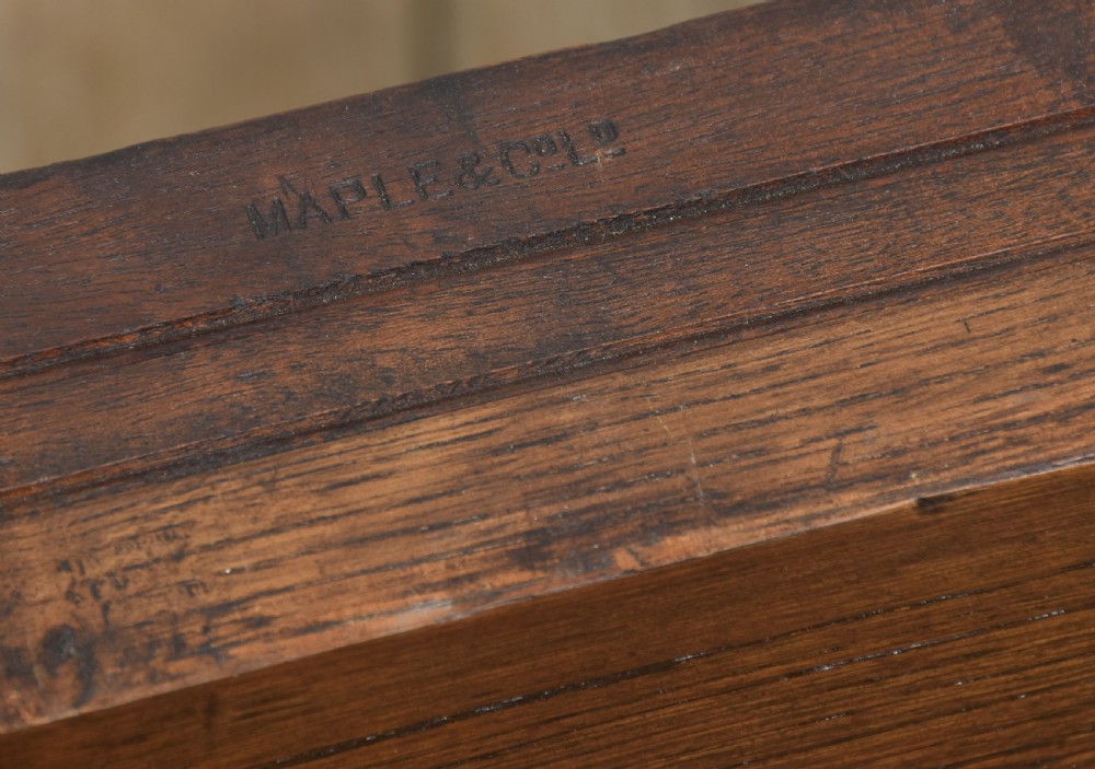 A dark oak extending dining table with carved bulbous legs and an H-stretcher base. View XV