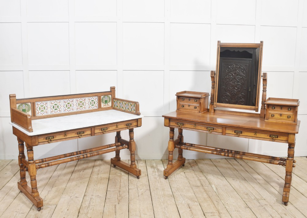 A pair of Aesthetic Movement bedroom tables comprising a marble-top tiled-back washstand and a matching dressing table with tilting mirror.
