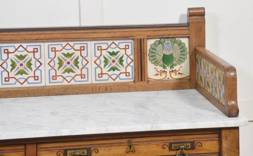A pair of Aesthetic Movement bedroom tables comprising a marble-top tiled-back washstand and a matching dressing table with tilting mirror. View III