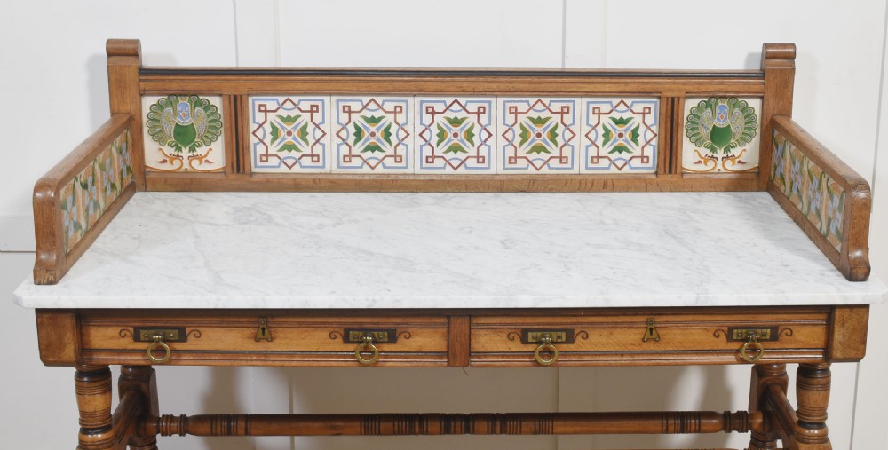 A pair of Aesthetic Movement bedroom tables comprising a marble-top tiled-back washstand and a matching dressing table with tilting mirror. View IV