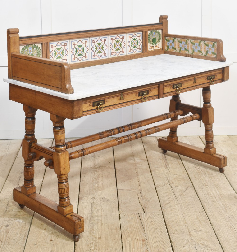 A pair of Aesthetic Movement bedroom tables comprising a marble-top tiled-back washstand and a matching dressing table with tilting mirror. View V
