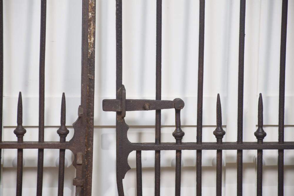 A pair of 19th-century wrought and cast iron gates featuring arched hoop tops, vertical pales, and central spearhead finials. View V
