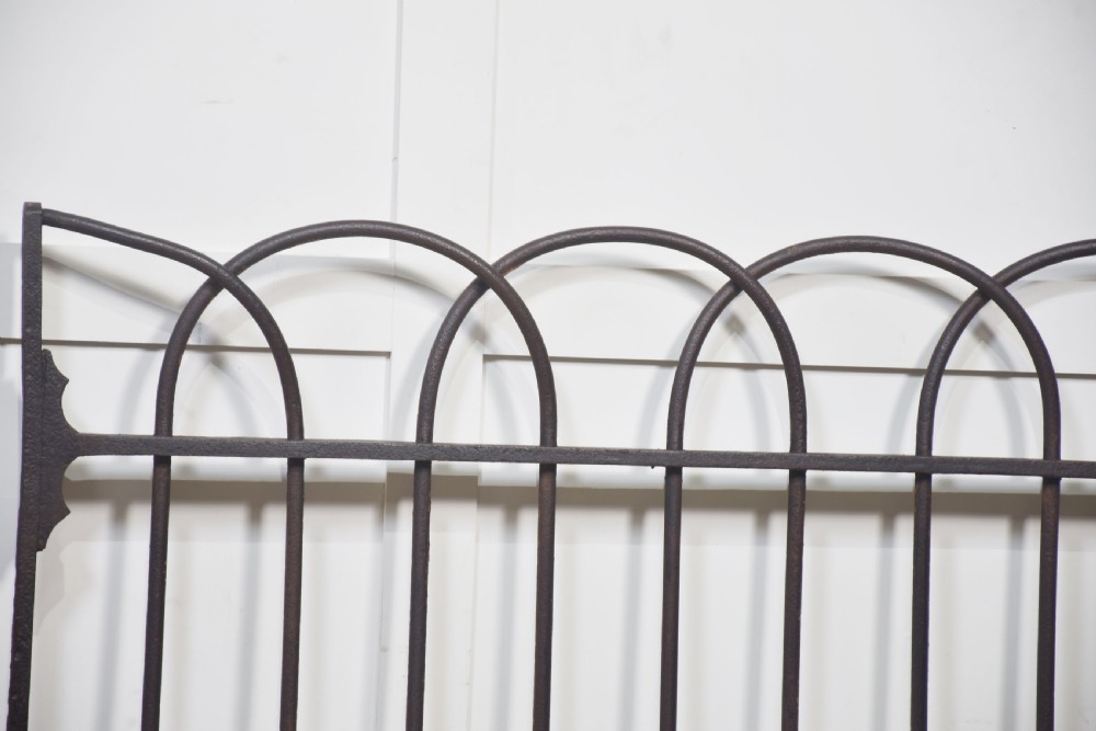 A pair of 19th-century wrought and cast iron gates featuring arched hoop tops, vertical pales, and central spearhead finials. View VI