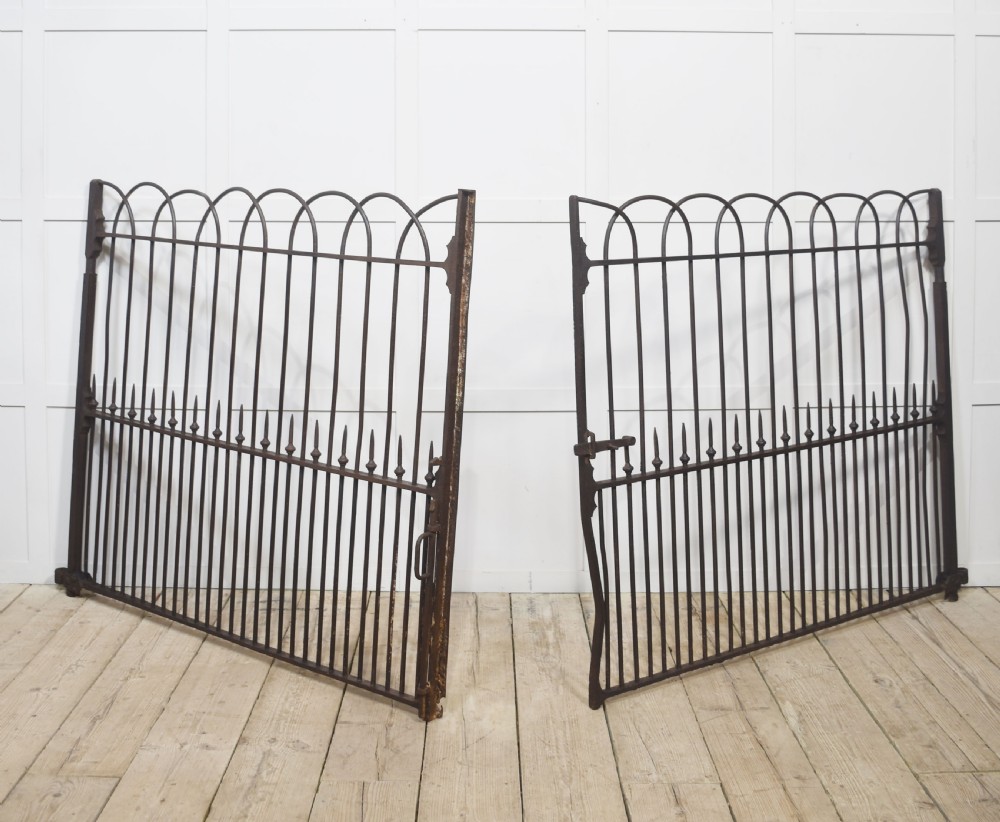 A pair of 19th-century wrought and cast iron gates featuring arched hoop tops, vertical pales, and central spearhead finials. View VII