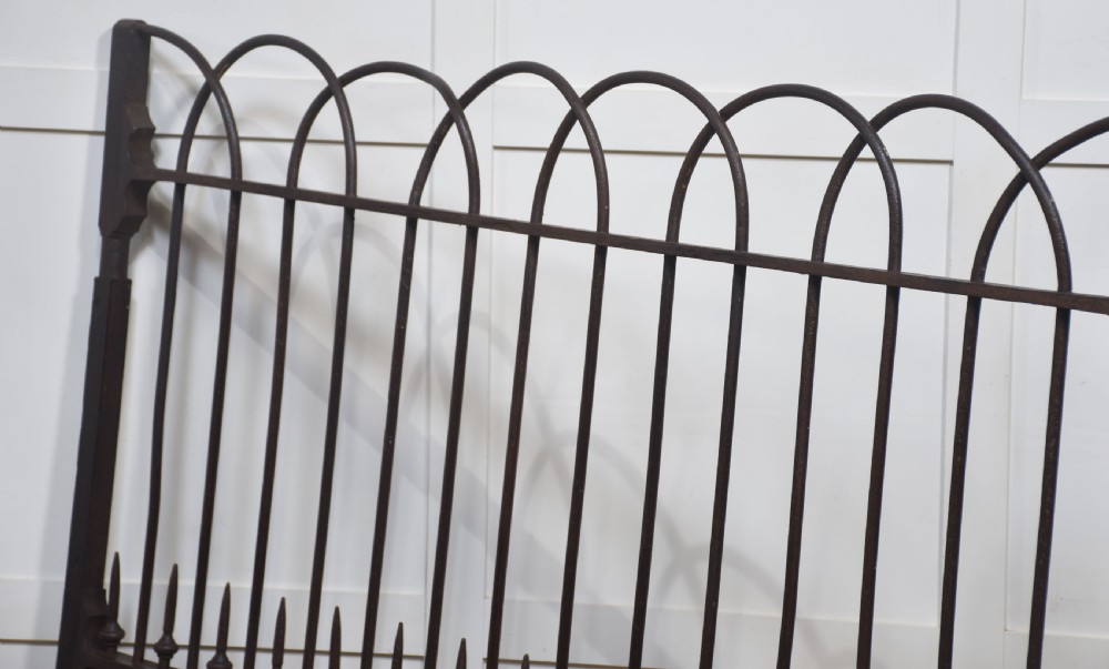 A pair of 19th-century wrought and cast iron gates featuring arched hoop tops, vertical pales, and central spearhead finials. View IX