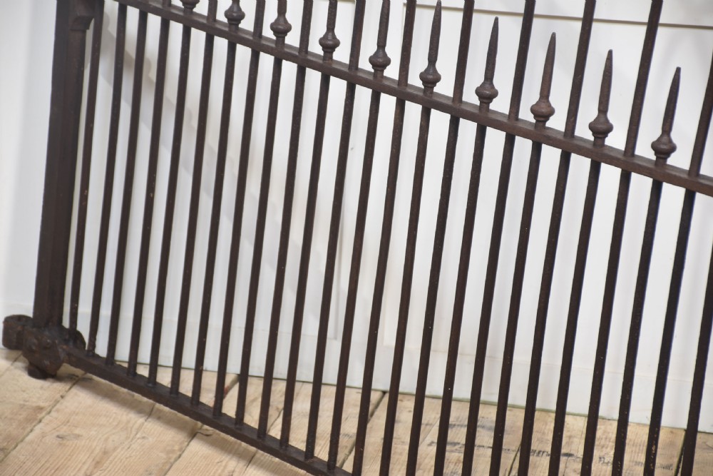 A pair of 19th-century wrought and cast iron gates featuring arched hoop tops, vertical pales, and central spearhead finials. View X